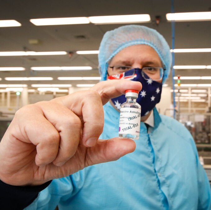 Prime Minister Scott Morrison holding a vial of COVID-19 vaccine at a manufacturing facility