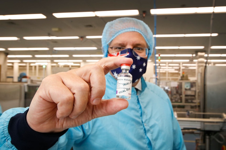 Prime Minister Scott Morrison holding a vial of COVID-19 vaccine at a manufacturing facility