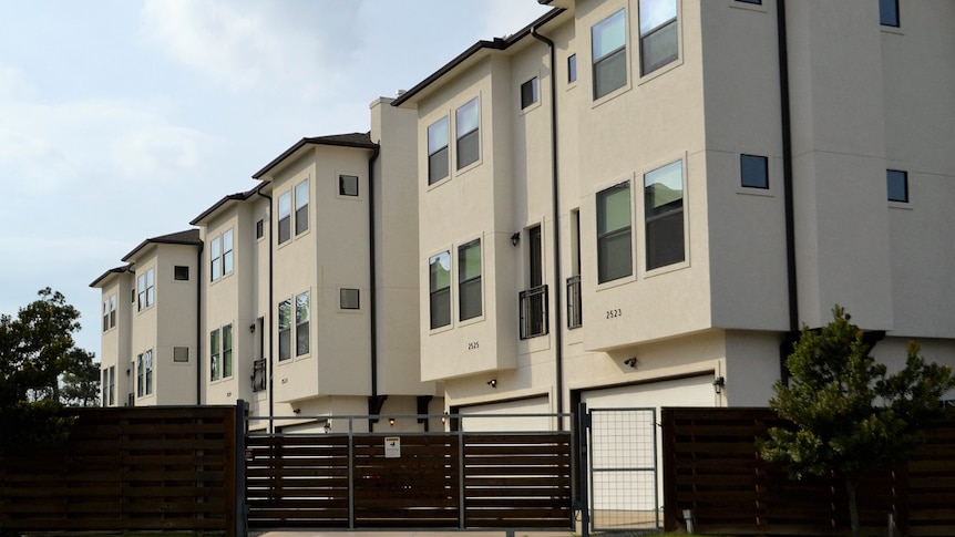 A block of apartments three stories high.