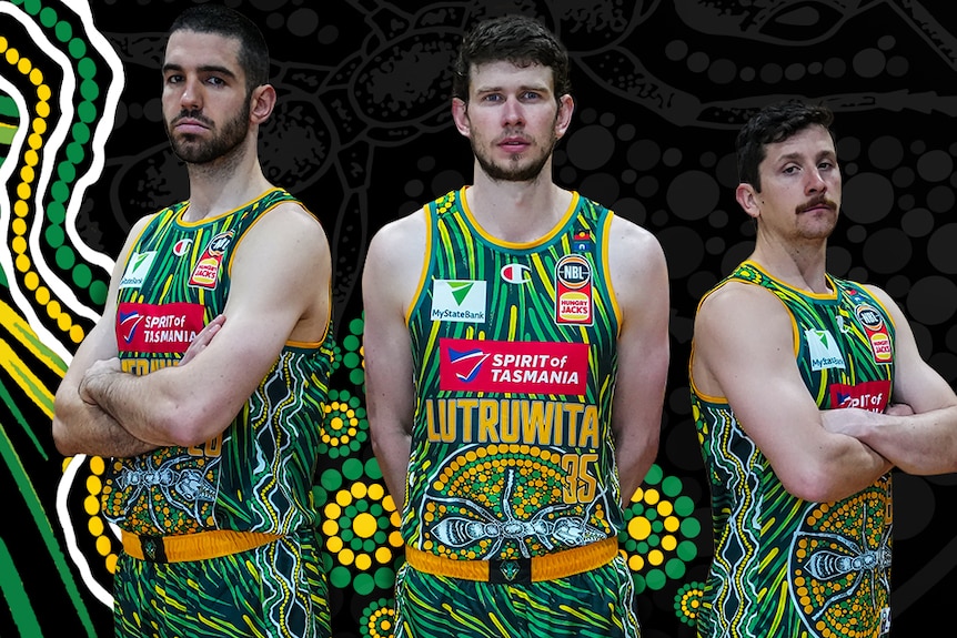Three Tasmania JackJumpers basketball team players in Indigenous design uniform.