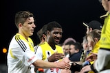 Wellington Phoenix players celebrate with fans after beating Central Coast in the FFA Cup