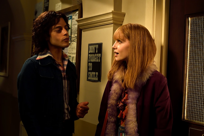 Colour still of Rami Malek as Freddie Mercury and Lucy Boynton as Mary Austin in 2018 film Bohemian Rhapsody.