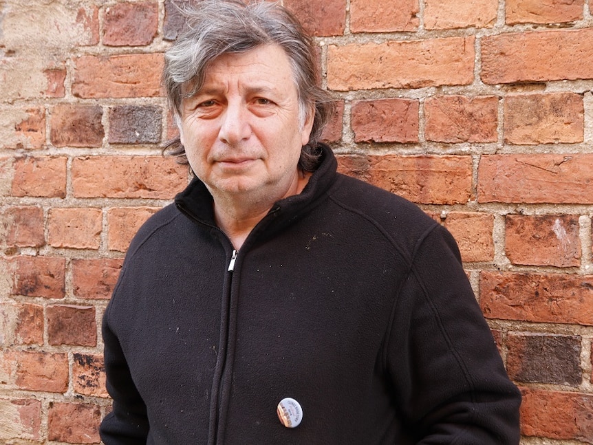 Book trader Vincent Ioannucchi standing in front of a wall.