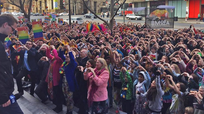 Everyone at the marriage equality rally in Adelaide makes a heart sign, July 25 2015.