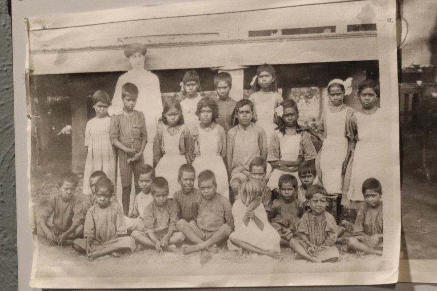 A group of 4 black and white photos of children