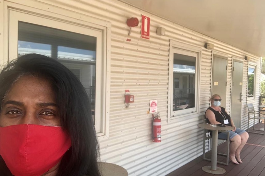 Throshni Naidoo wearing a face mask, in a selfie taken on the verandah of a worker cabin.