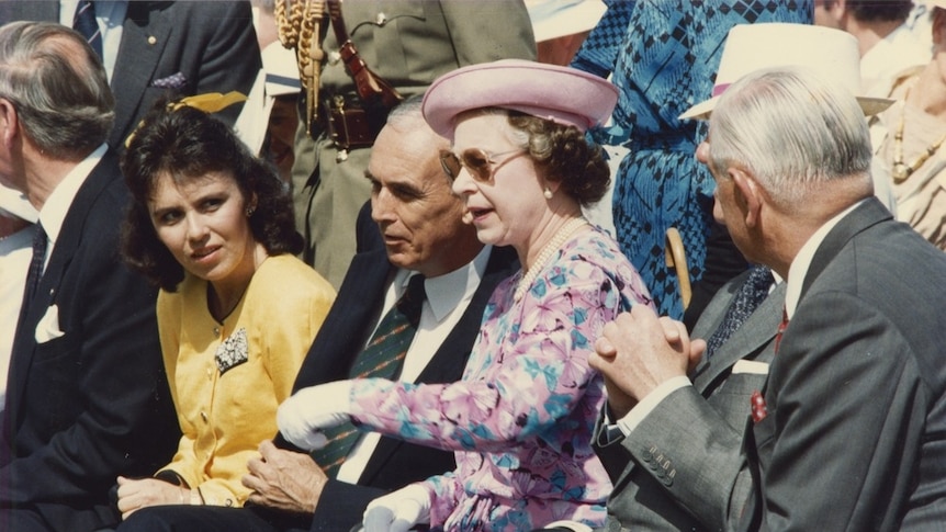 Queen Elizabeth II watching the opening performance at the River Stage at Expo 88