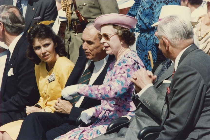 Queen Elizabeth II watching the opening performance at the River Stage at Expo 88