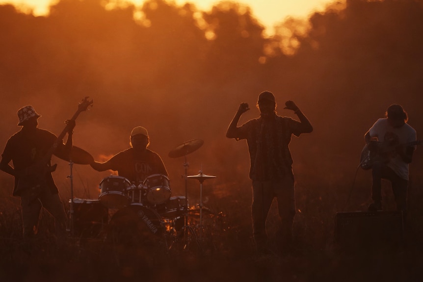 A band silhouetted at sunset.