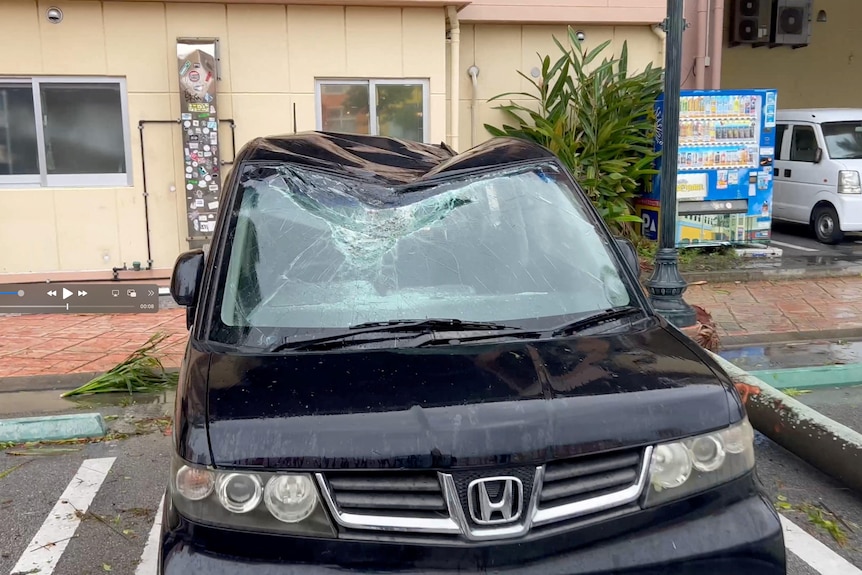 A view of a car damaged during heavy rain and strong winds brought by Typhoon Khanun in Chatan