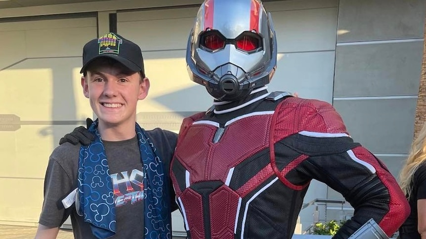 Toby Holt smiles with his arm wrapped around Ant-Man