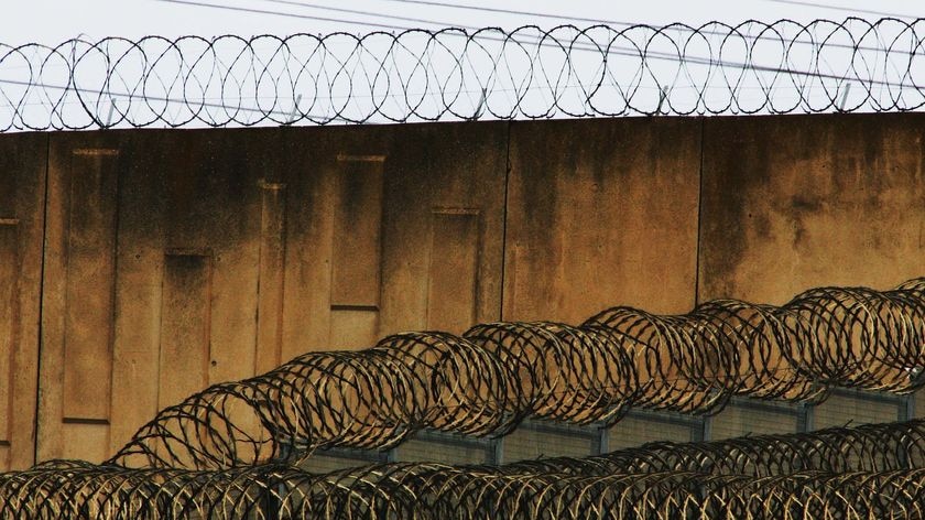 Razor wire atop a prison wall