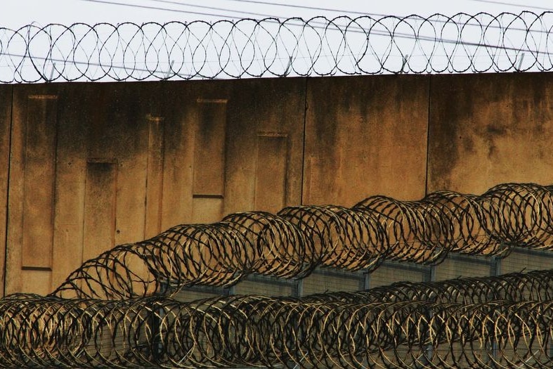 Razor wire atop a prison wall