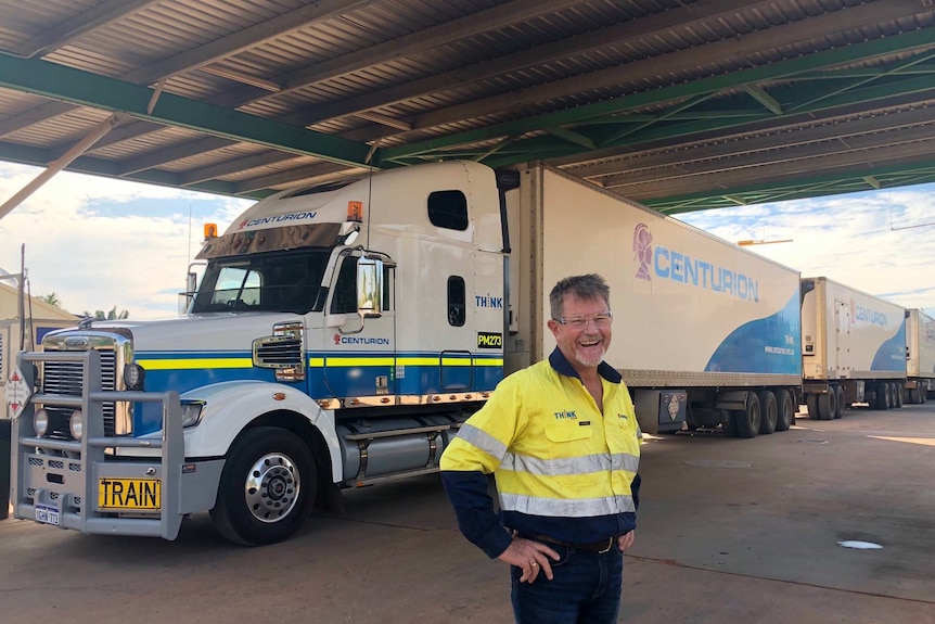 Truck driver Marty Baldwin standing with his triple road train