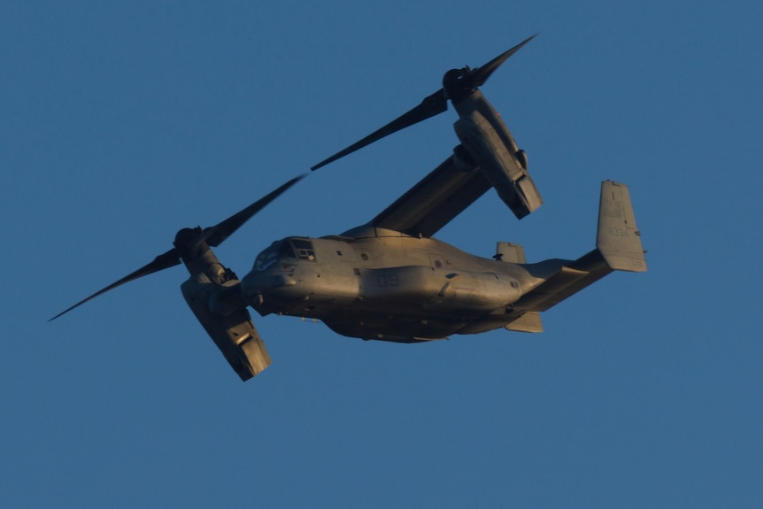 An aircraft, half plane and half helicopter, flies in clear skies