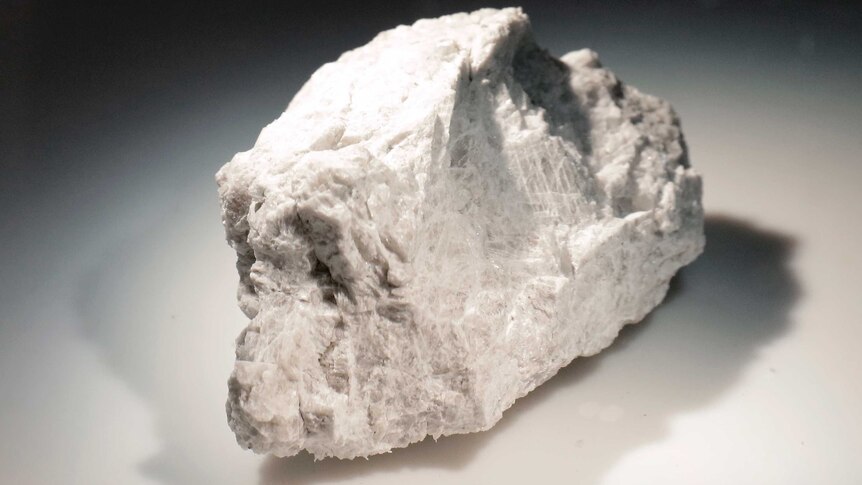 A white rock is lit inside a pressurized nitrogen-filled examination case.