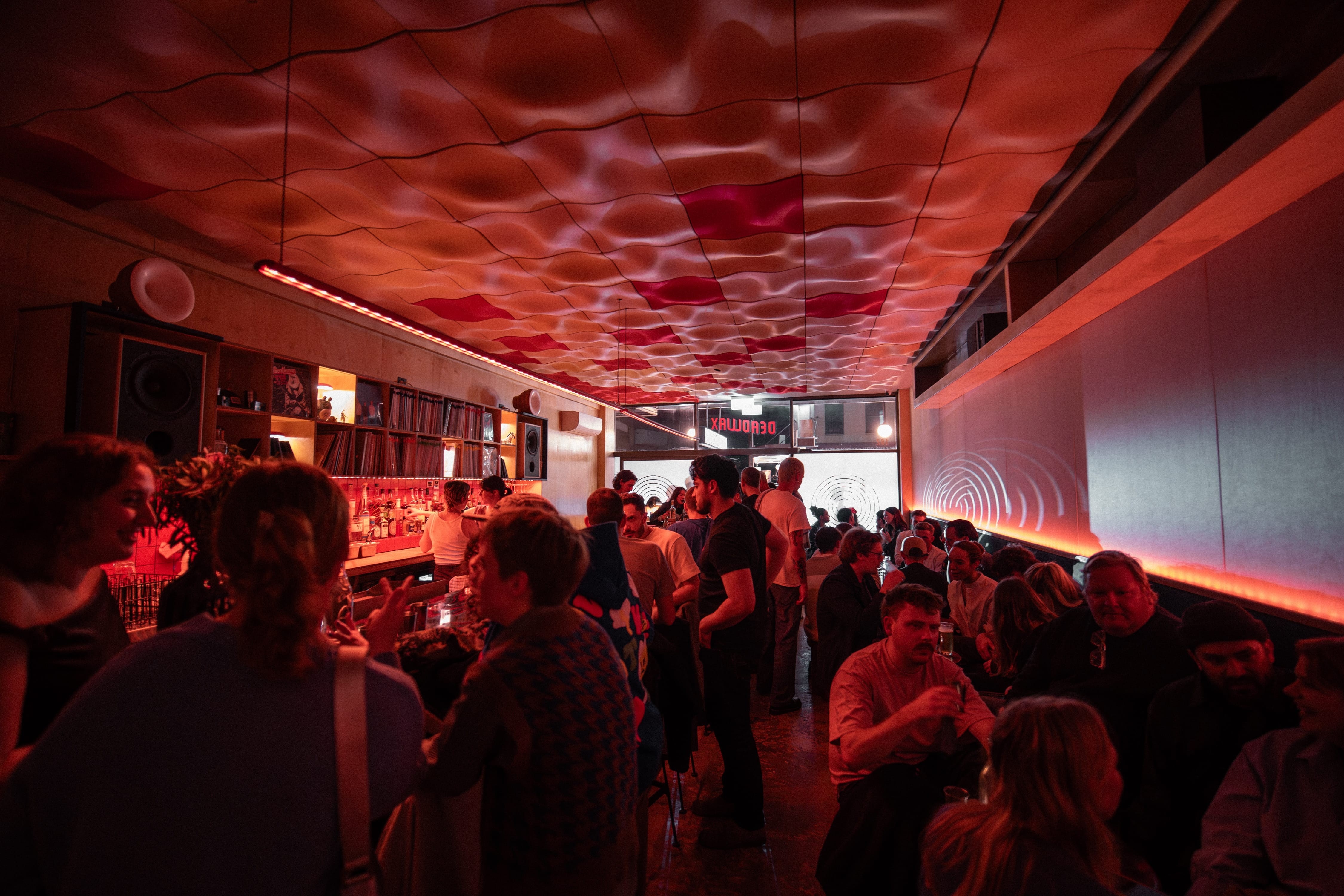 people inside a dark small bar called deadwax in enmore in sydney