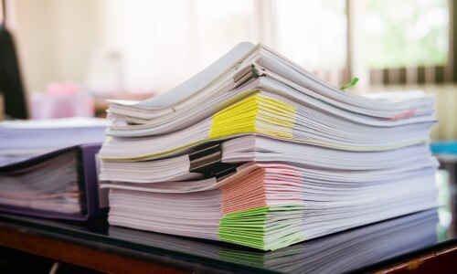 A pile of papers on a desk