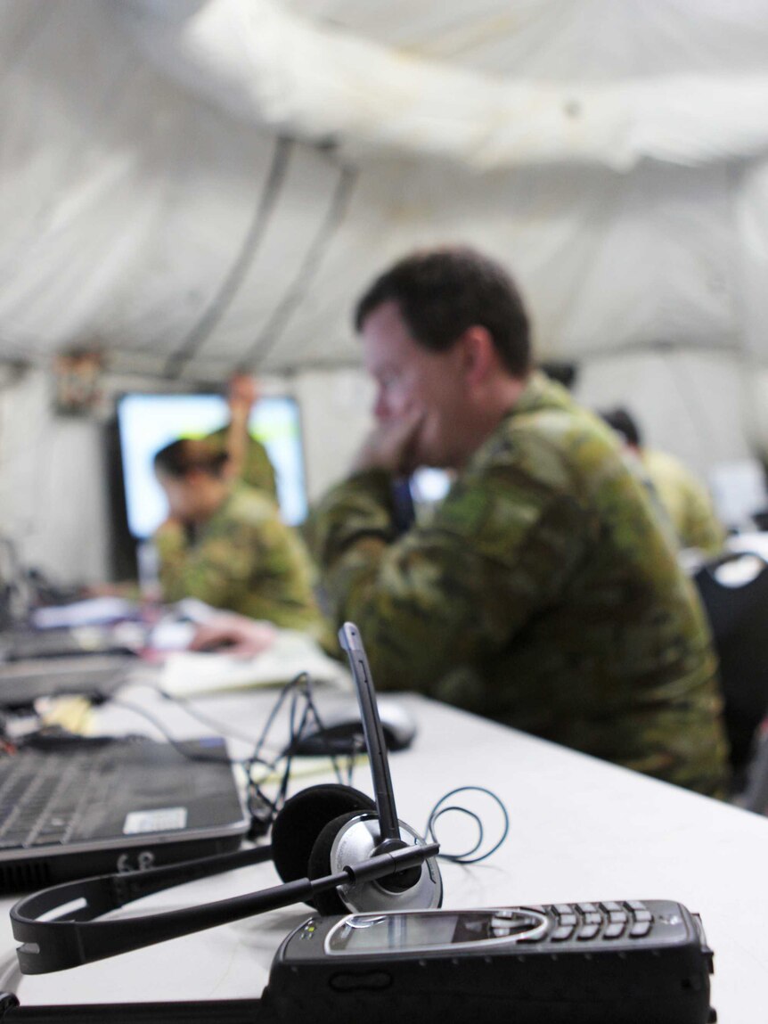 Portrait of a man in ADF uniform on a computer