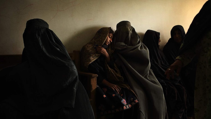 A mother waits with her daughter in the emergency waiting room at a MSF administered hospital.