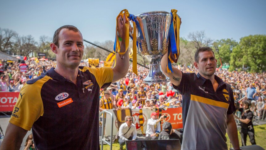 Captains Luke Hodge and Shannon Hurn with the 2015 AFL cup.