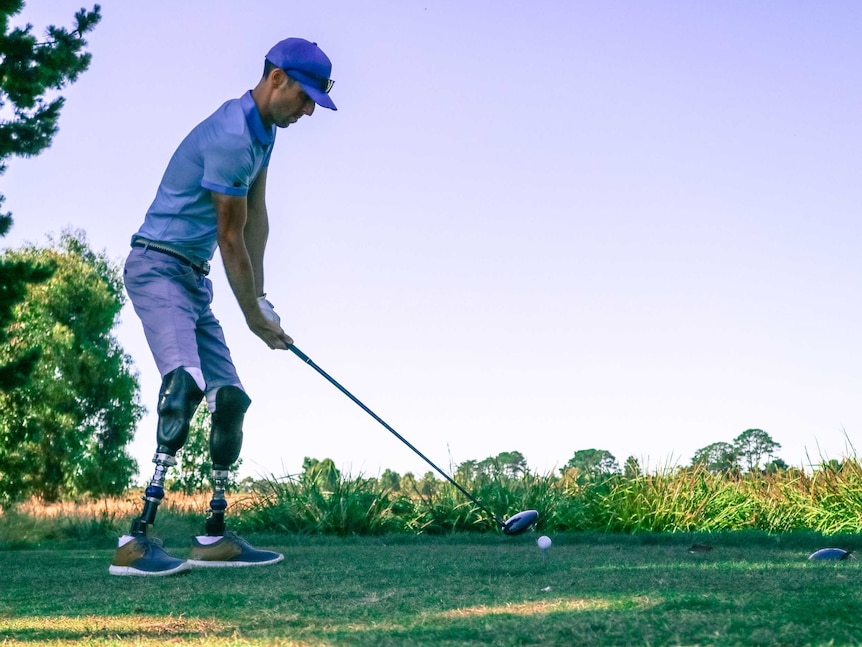 Mike Rolls aiming his driving golf club at a ball