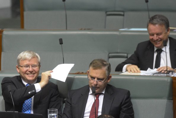 Labor backbencher Kevin Rudd smiles during question time.