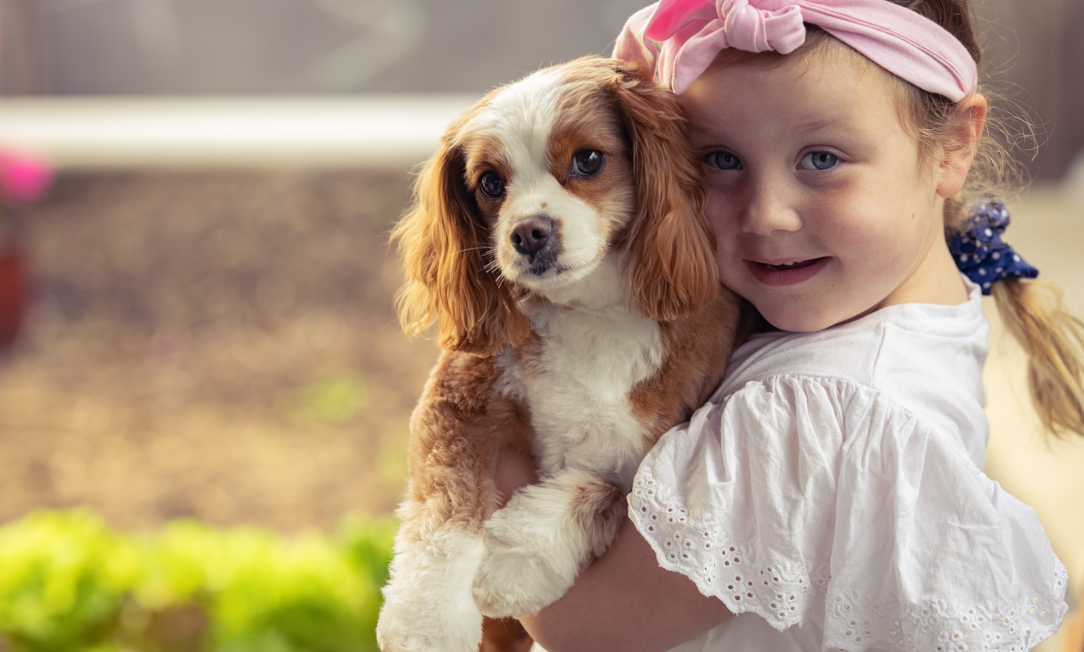 Five year old Tilly hugs her dog. 