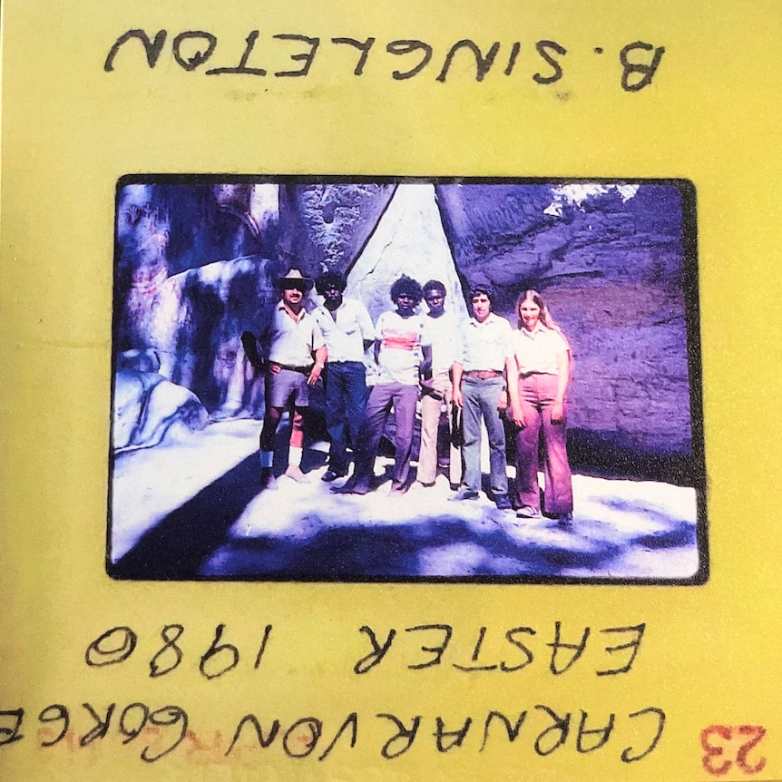 A group of people in a gorge pictured in an old slide.