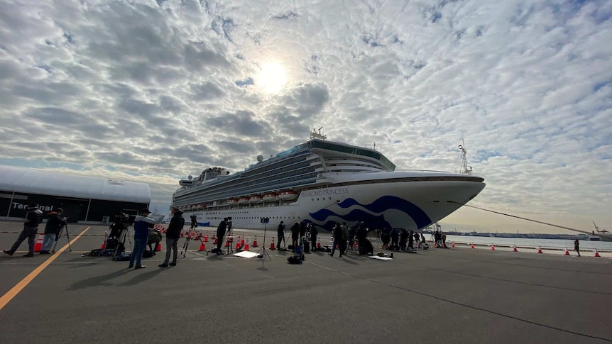 A cruise ship against a cloudy sky.