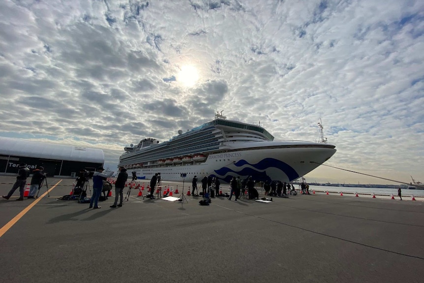 A cruise ship against a cloudy sky.