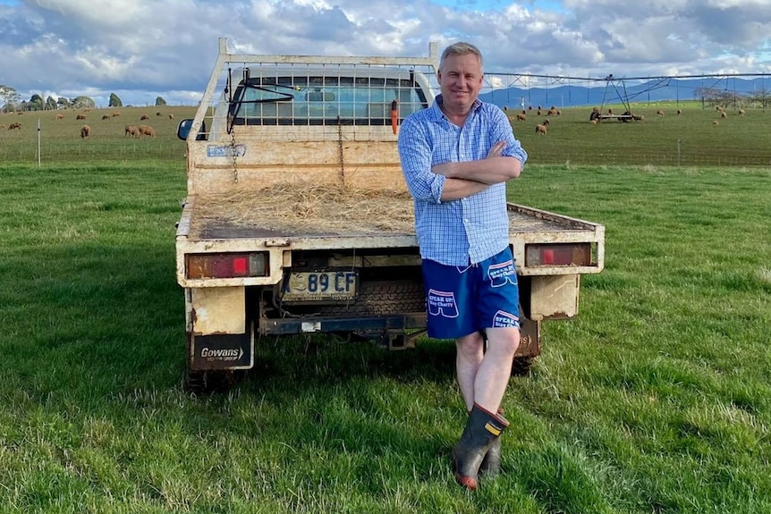 Jeremy Rockliff leans against a ute at his farm.