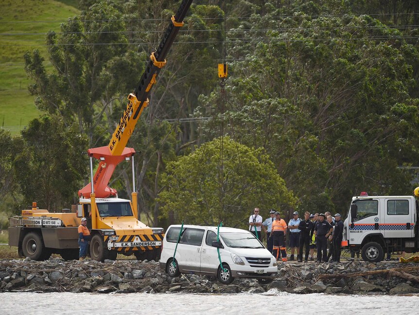 A car is removed from the Tweed River near Tumbulgum where a mother and her two children died.