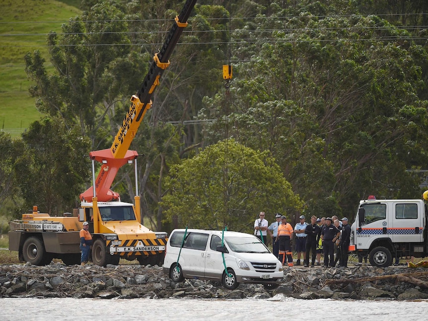 A car is removed from the Tweed River near Tumbulgum where a mother and her two children died.