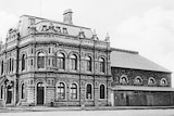 A black and white photo of a photo of the Trades Hall in the early 1900s.