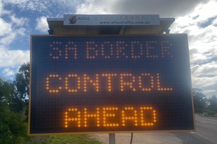 A sign by the side of the road that says 'SA Border Controls Ahead'.