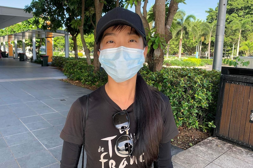 A woman wearing a surgical face mask