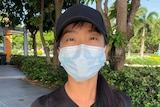 A woman wearing a surgical face mask