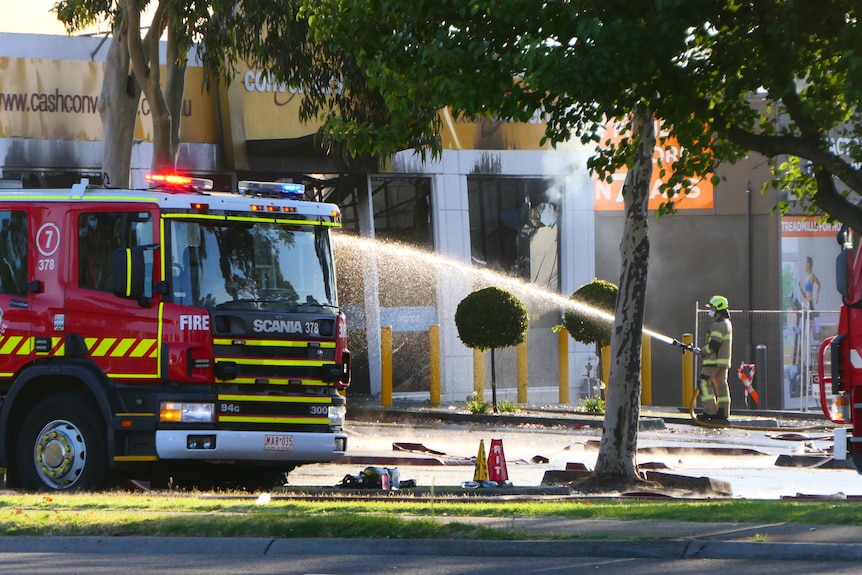 A firefighter using a hose.