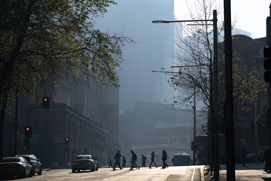 People walking through a smoky Sydney CBD