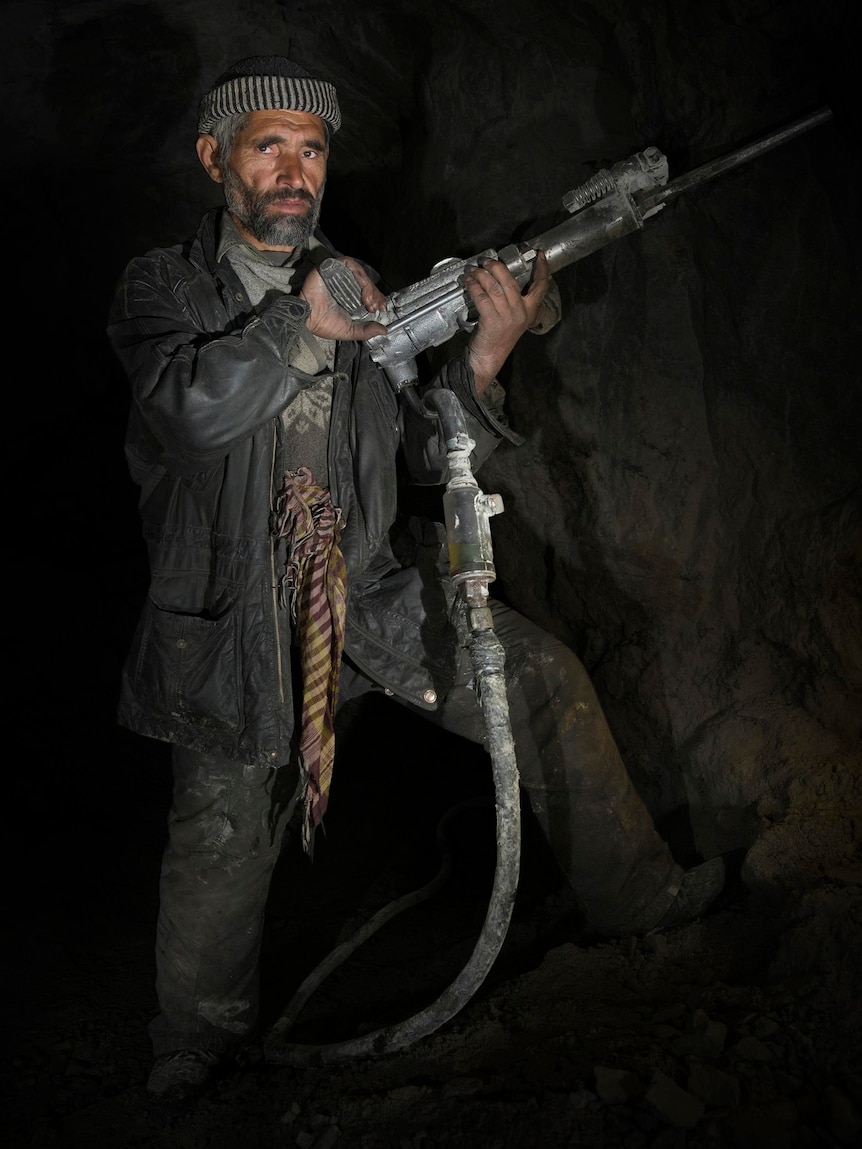 An underground gem miner works the airleg drill in the Karakorum Range of northern Pakistan.