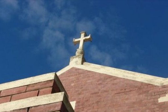 Cross on top of a church building.