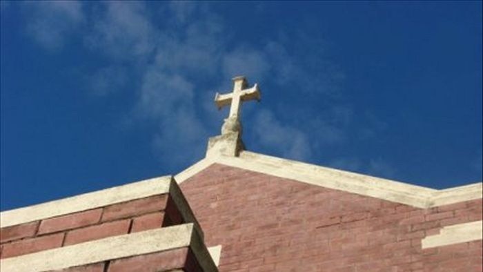 Cross on top of a church building.