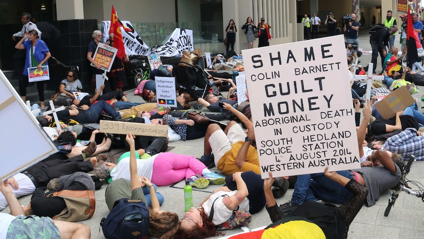 Protesters laid down on the ground outside the law courts in unison in a 'die-in', representing what they say is still too many Aboriginal deaths in custody 25 years on from a Royal Commission