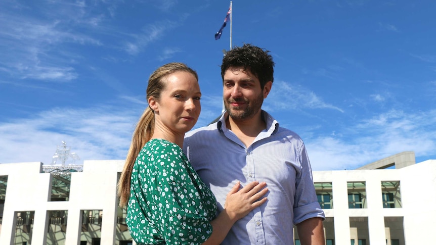 Rachael and Jonny Casella stand outside parliament house.