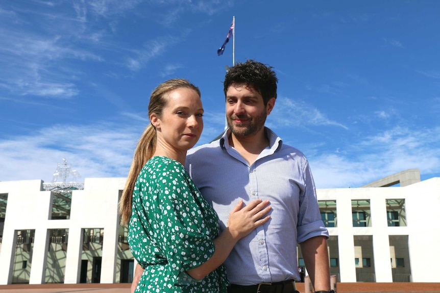 Rachael and Jonny Casella stand outside parliament house.