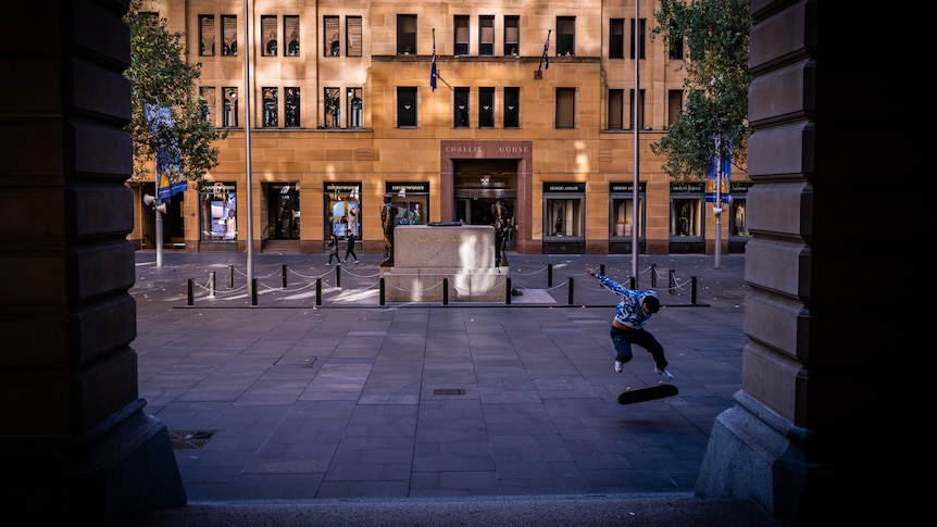 a person skateboarding in an empty city square