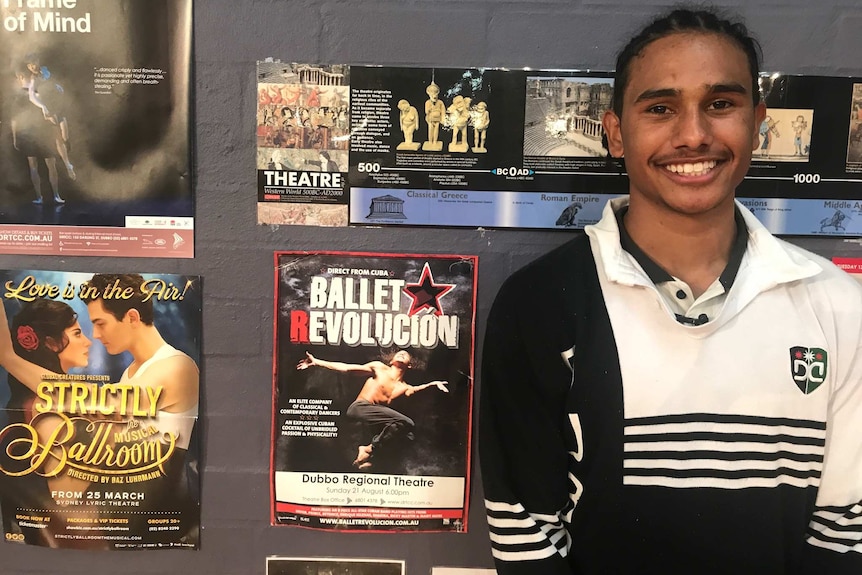 17-year-old aspiring dancer Ngali Shaw stands next to theatre posters