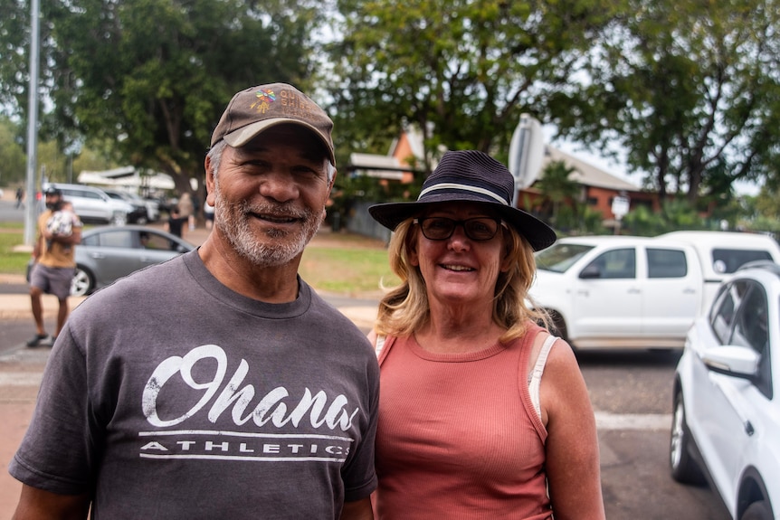 A man and a woman stand next to each other.