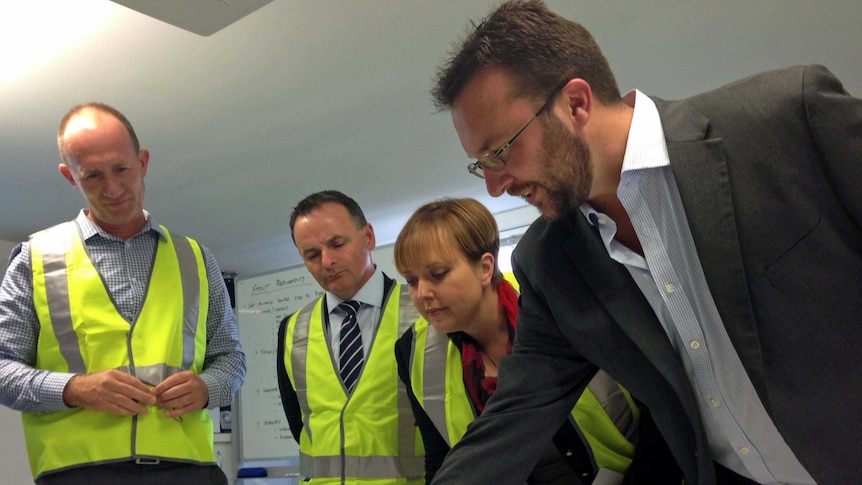 Tasmanian Premier Lara Giddings looks over plans for a construction company development at Margate.